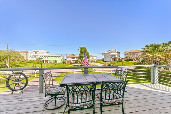 a balcony with table and chairs