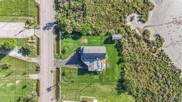an aerial view of a house with garden space and street view