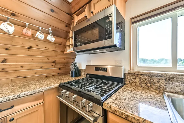 a kitchen with stainless steel appliances granite countertop a refrigerator and a sink