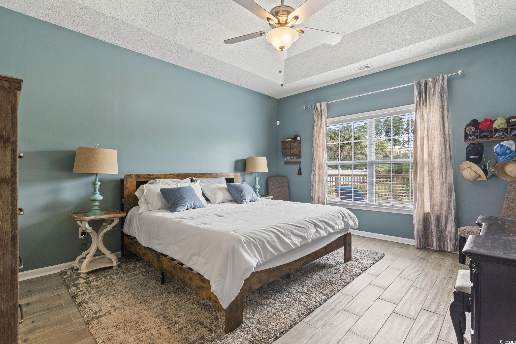 212 Duchess Court Myrtle Beach, SC 29588 - Photo 14 of 40 Bedroom with a tray ceiling, porcelain tiled floors, a ceiling fan