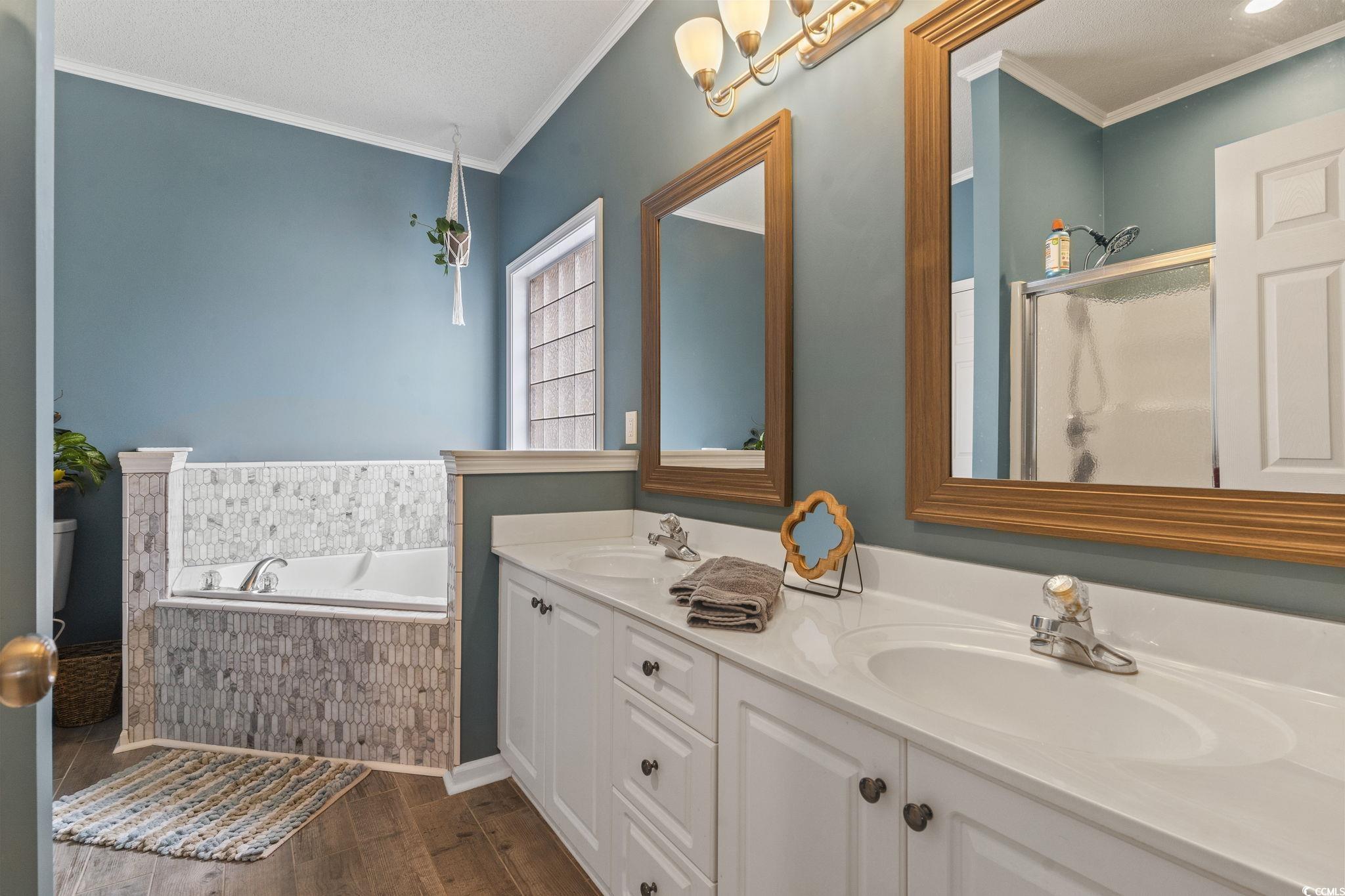 212 Duchess Court Myrtle Beach, SC 29588 - Photo 15 of 40 Full bath featuring ornamental molding, double vanity, a garden tub porcelain tile flooring, and a separate shower with shower door