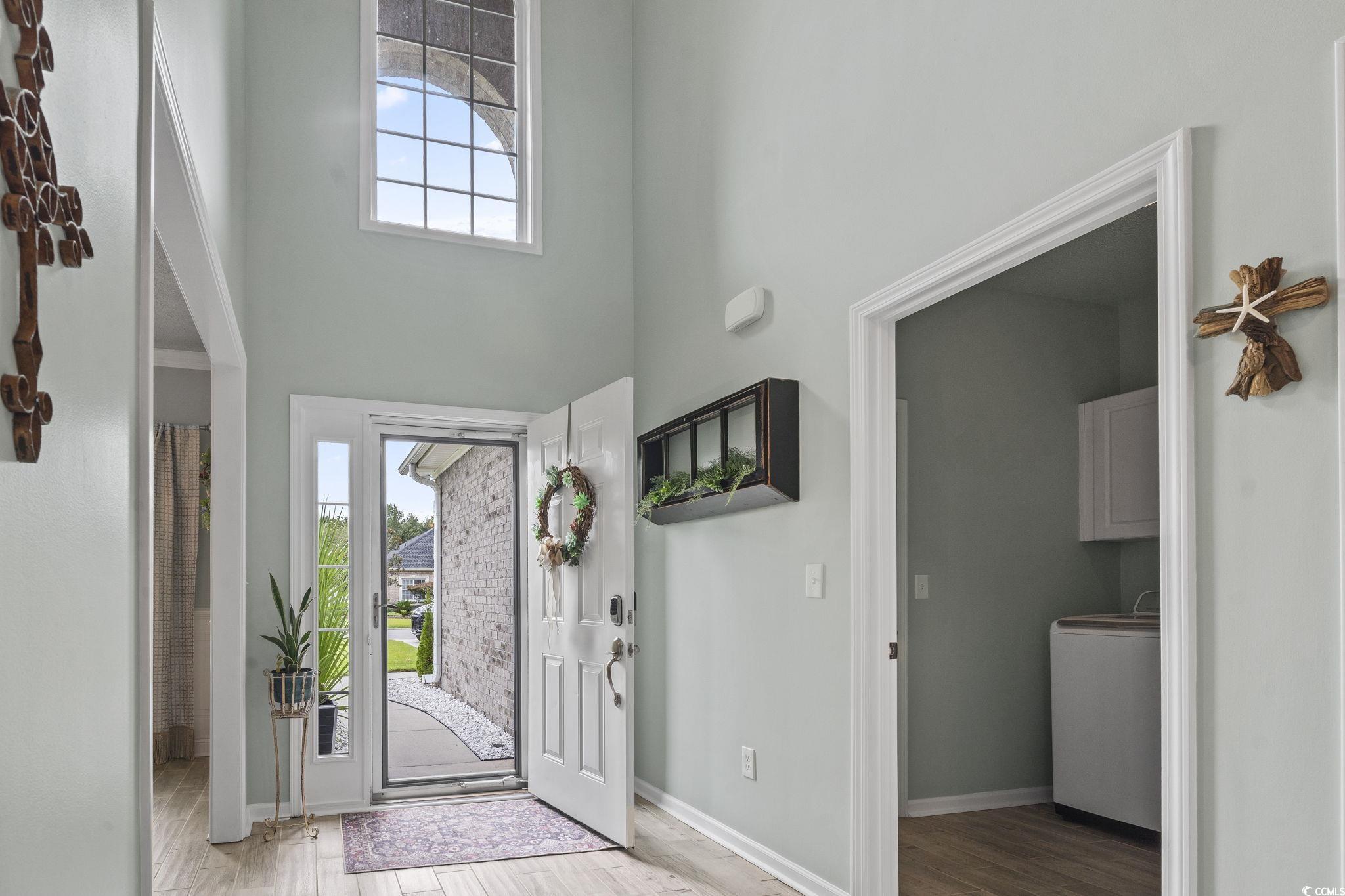 212 Duchess Court Myrtle Beach, SC 29588 - Photo 2 of 40 Foyer with light wood-type flooring, washer / dryer, and a high ceiling