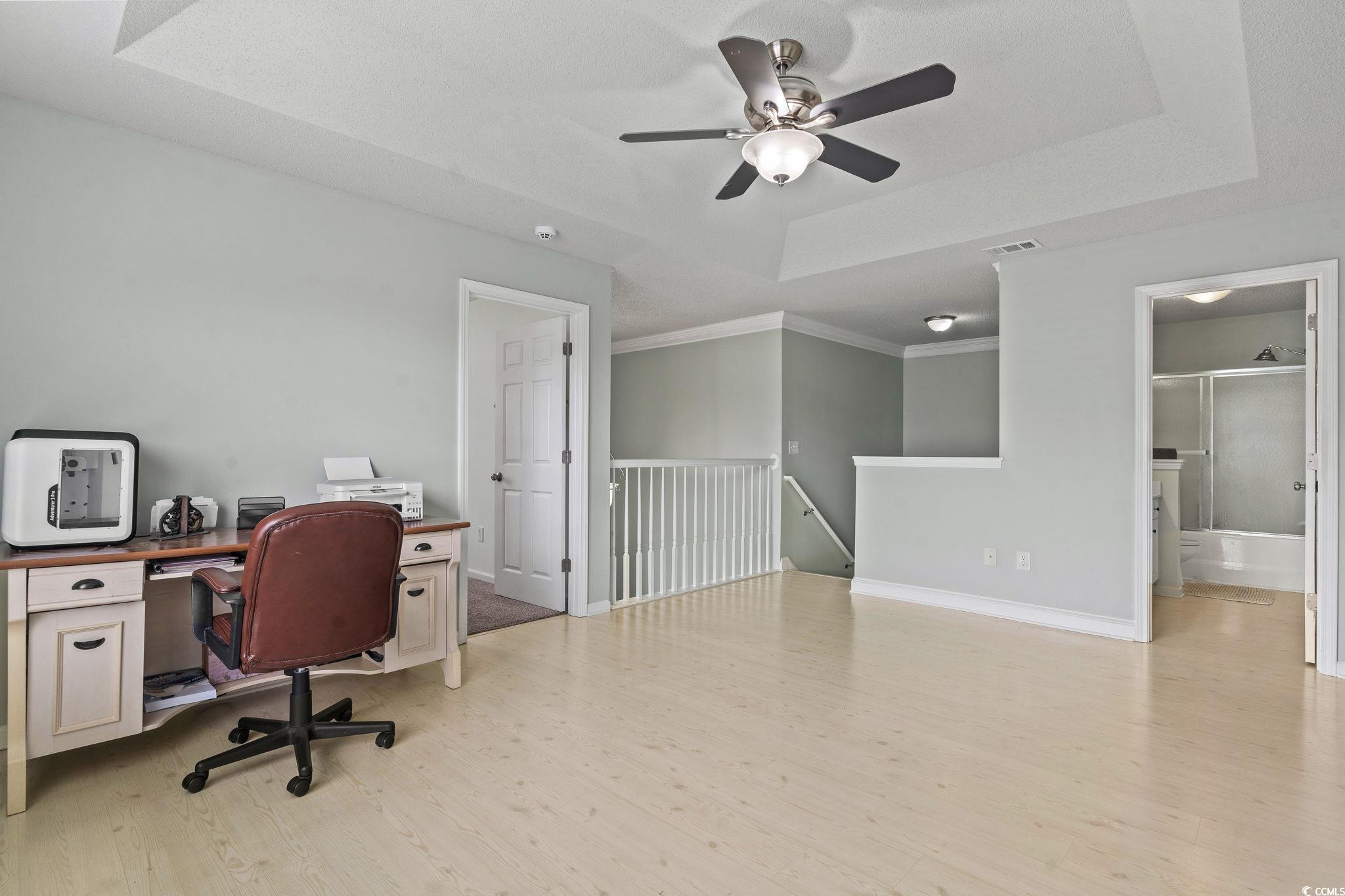 212 Duchess Court Myrtle Beach, SC 29588 - Photo 21 of 40 Bonus room/Office space featuring a raised ceiling, light wood-type flooring, and a ceiling fan