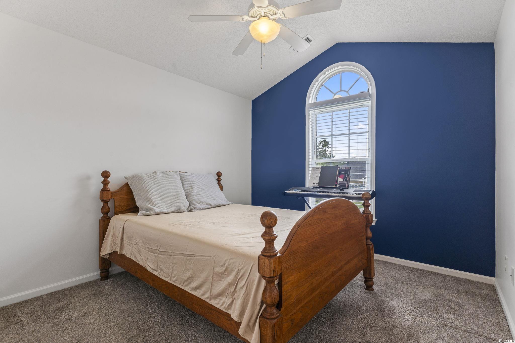 212 Duchess Court Myrtle Beach, SC 29588 - Photo 23 of 40 Bedroom with vaulted ceiling, a ceiling fan, and carpet