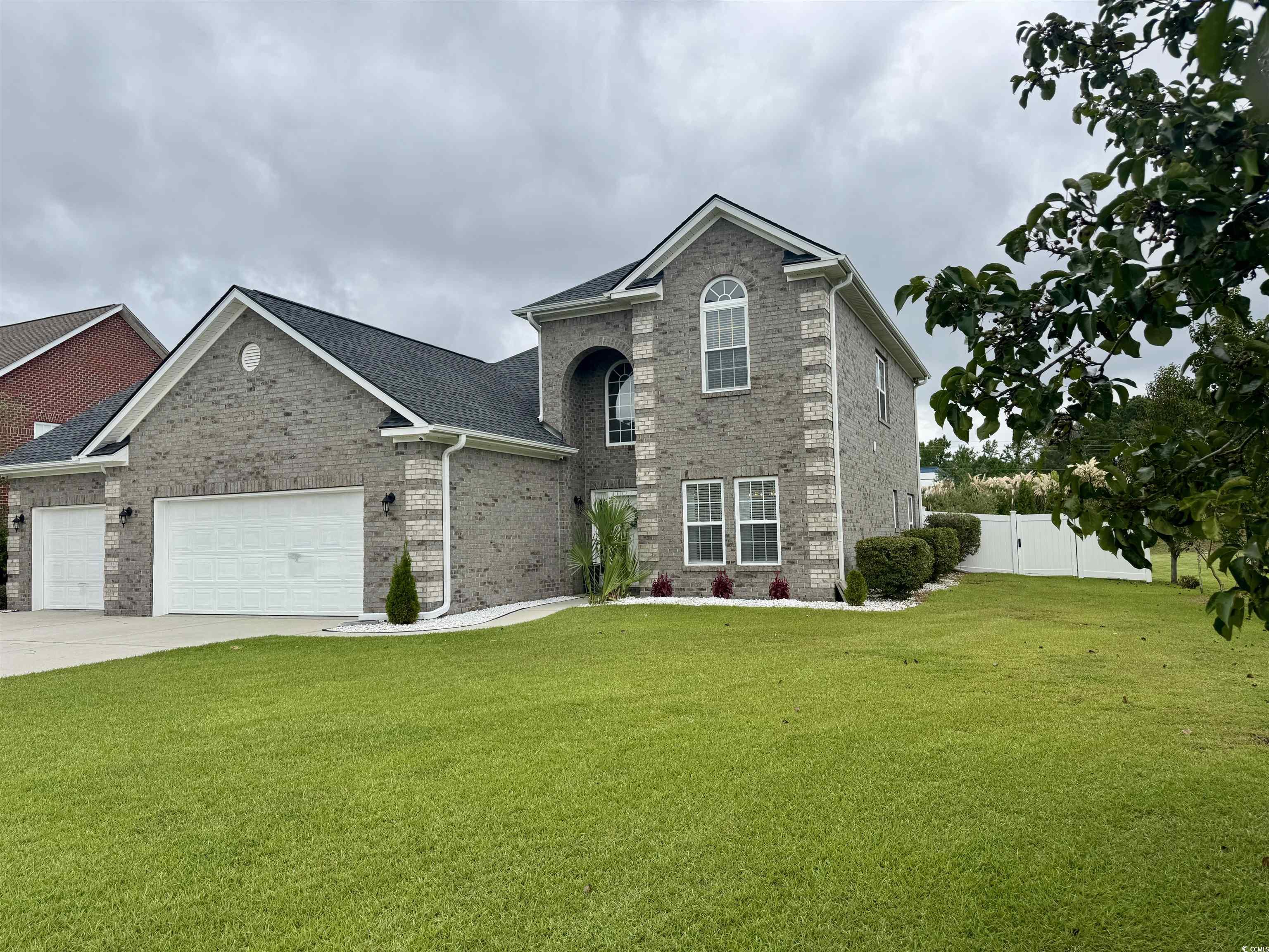 212 Duchess Court Myrtle Beach, SC 29588 - Photo 36 of 40 Traditional-style house with brick siding, an attached garage, and driveway