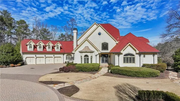an aerial view of a house with a yard swimming pool