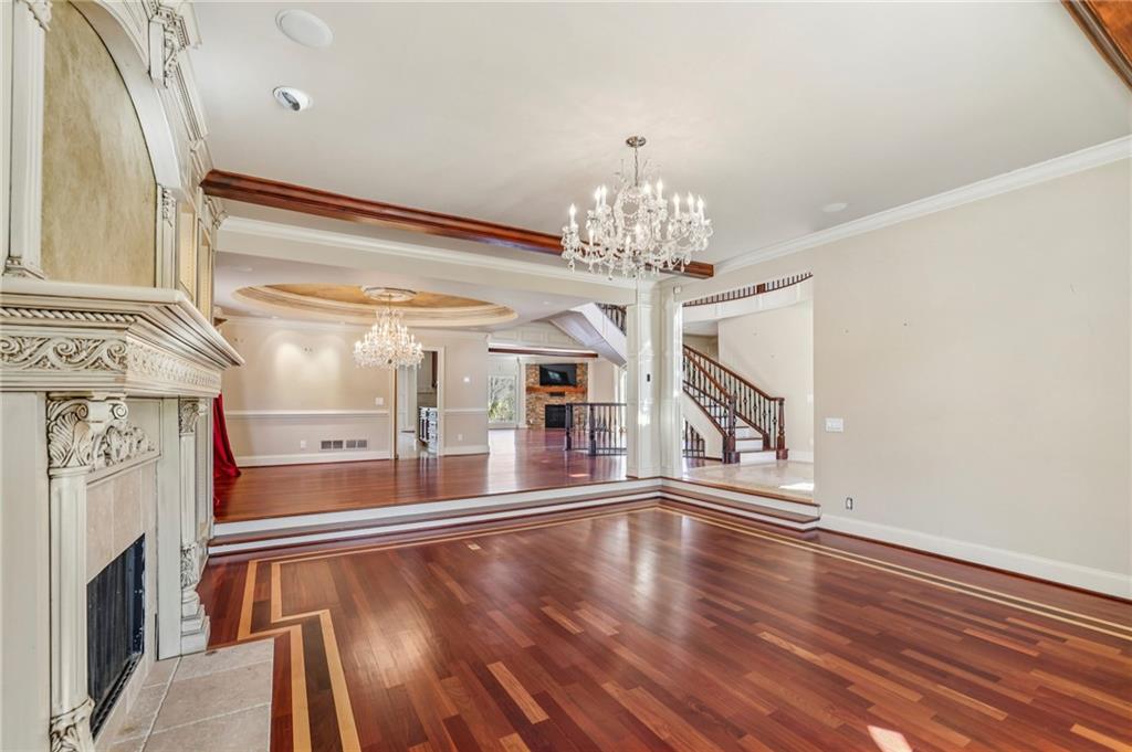 6525 Garrett Road Buford, GA 30518 - Photo 17 of 98 a view of a room with chandelier and wooden floor