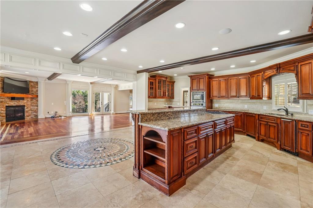 6525 Garrett Road Buford, GA 30518 - Photo 23 of 98 a large kitchen with stainless steel appliances granite countertop a large stove a sink and a large island