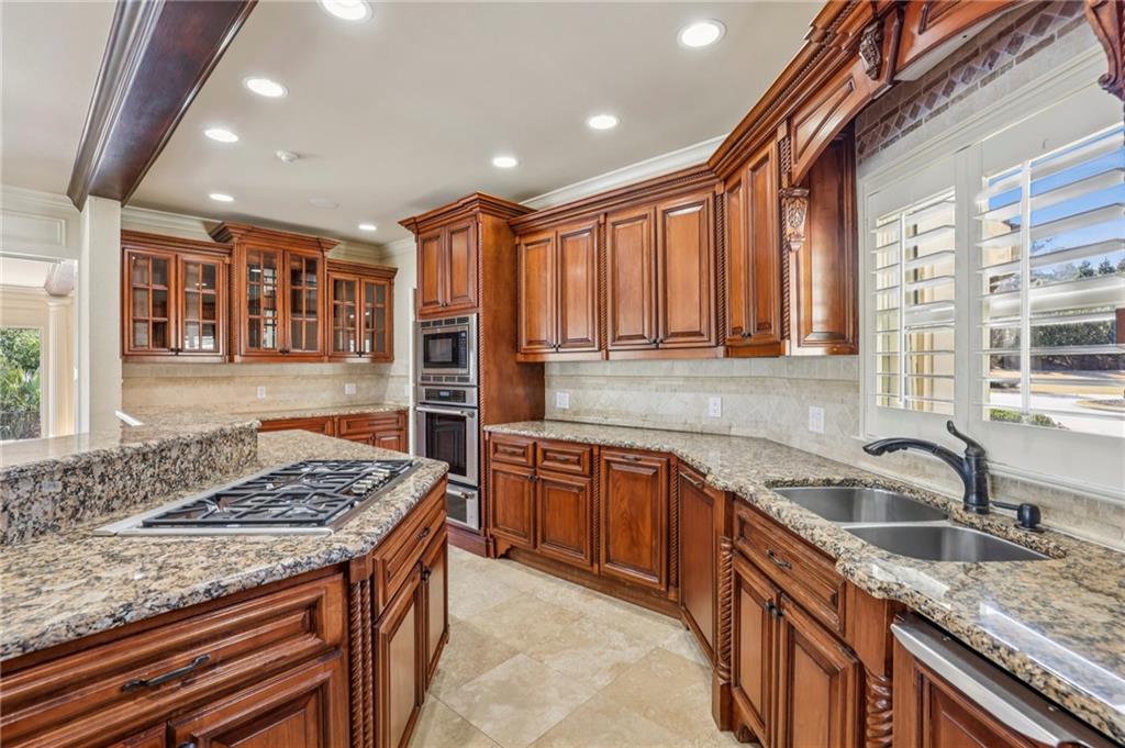 6525 Garrett Road Buford, GA 30518 - Photo 24 of 98 a kitchen that has a sink and a stove