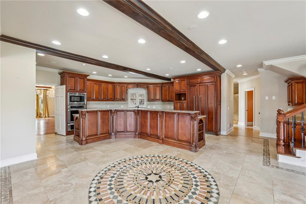 6525 Garrett Road Buford, GA 30518 - Photo 25 of 98 a view of kitchen with stainless steel appliances kitchen island granite countertop a refrigerator and a sink