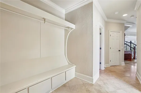 a large white kitchen with granite countertop a sink and dishwasher a stove top oven with wooden floor