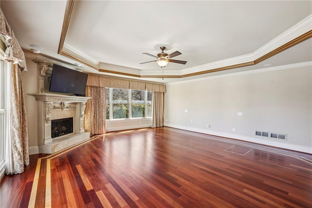 6525 Garrett Road Buford, GA 30518 - Photo 33 of 98 a view of an empty room with wooden floor fireplace and a window