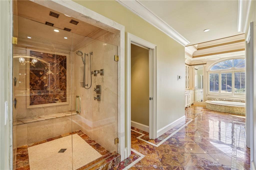 6525 Garrett Road Buford, GA 30518 - Photo 38 of 98 a bathroom with a tub shower and sink