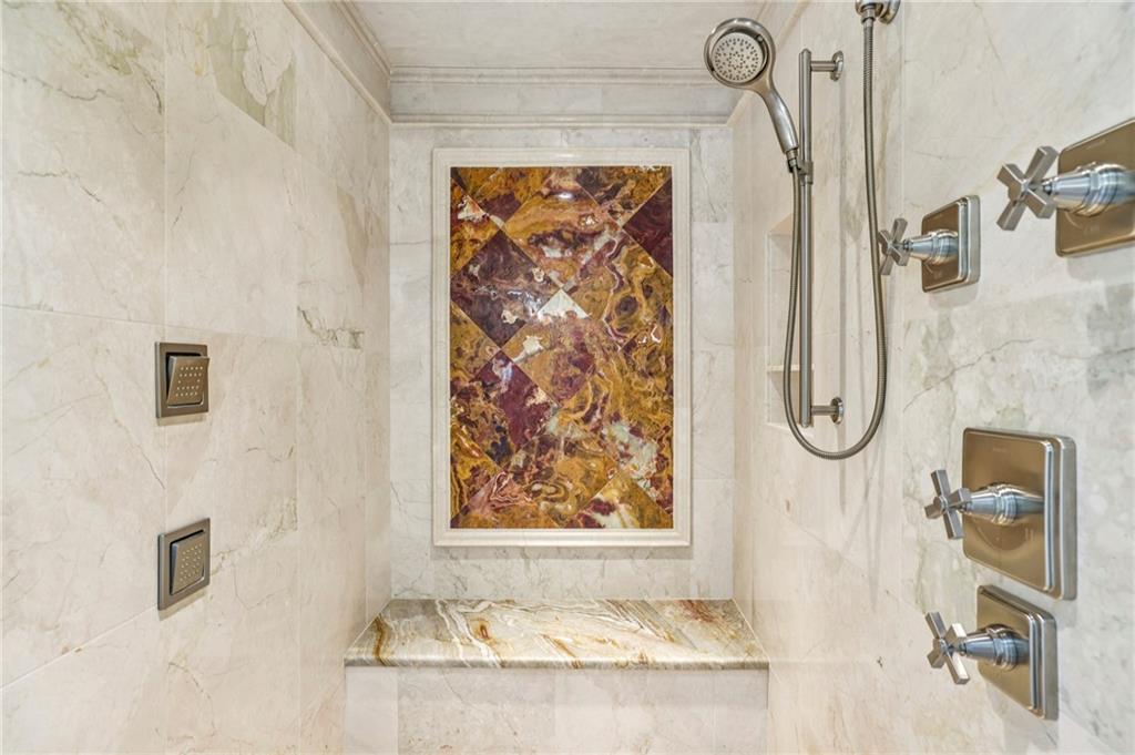 6525 Garrett Road Buford, GA 30518 - Photo 39 of 98 a bathroom with a granite countertop shower a sink and a mirror