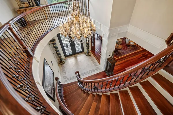 a view of a dining room with furniture a chandelier and wooden floor