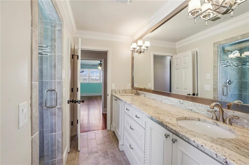 6525 Garrett Road Buford, GA 30518 - Photo 45 of 98 a bathroom with a granite countertop sink mirror and double