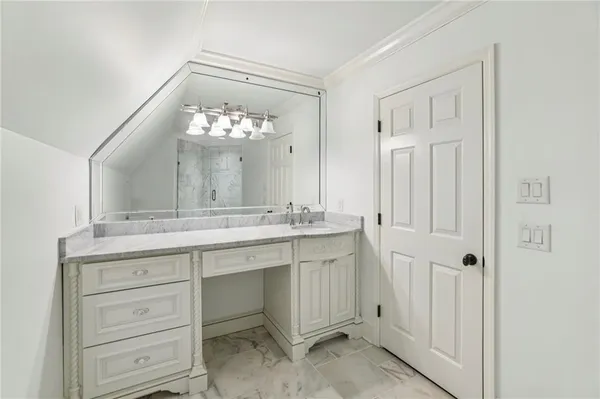 a spacious bedroom with a bed and wooden floor