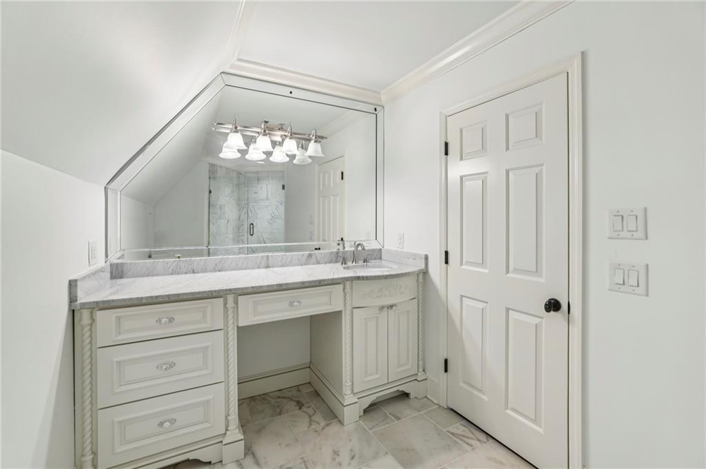 6525 Garrett Road Buford, GA 30518 - Photo 47 of 98 a bathroom with a double vanity sink and mirror