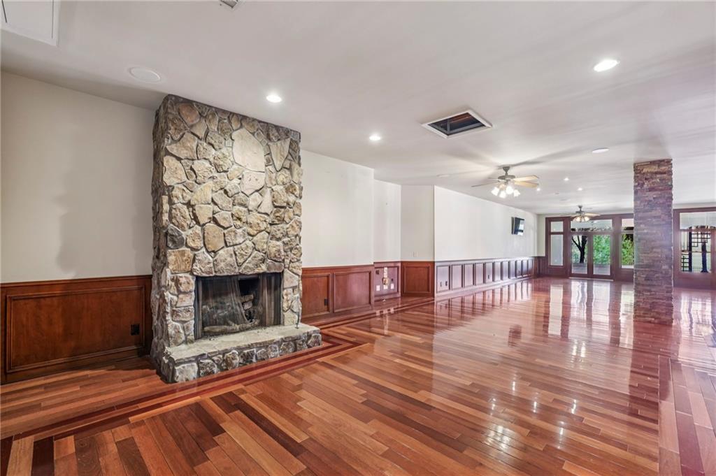 6525 Garrett Road Buford, GA 30518 - Photo 61 of 98 a living room with furniture a fireplace and a floor to ceiling window
