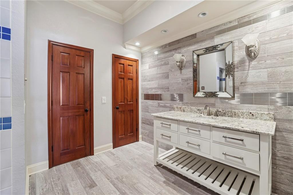 6525 Garrett Road Buford, GA 30518 - Photo 66 of 98 a bathroom with a sink a mirror and a shower