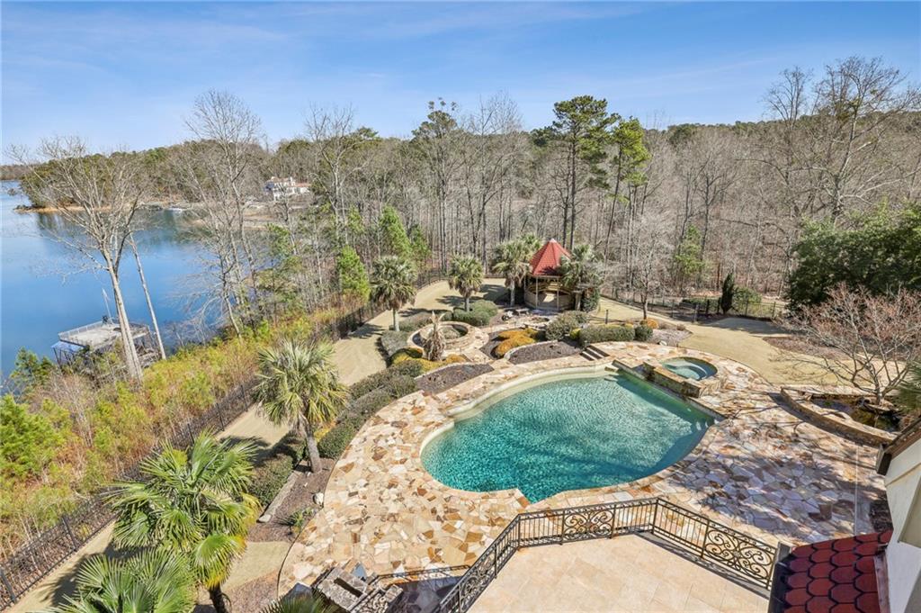 6525 Garrett Road Buford, GA 30518 - Photo 69 of 98 a view of a swimming pool with a yard and mountain in the background
