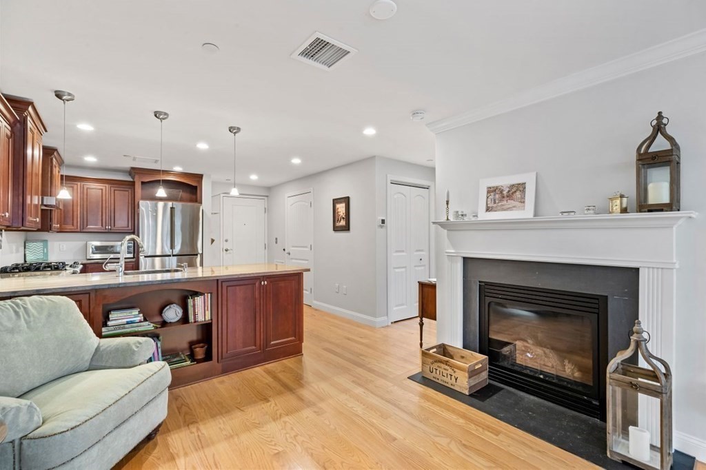 91 Front Street, Unit 104 Scituate, MA 02066 - Photo 11 of 26 a living room with furniture and a fireplace