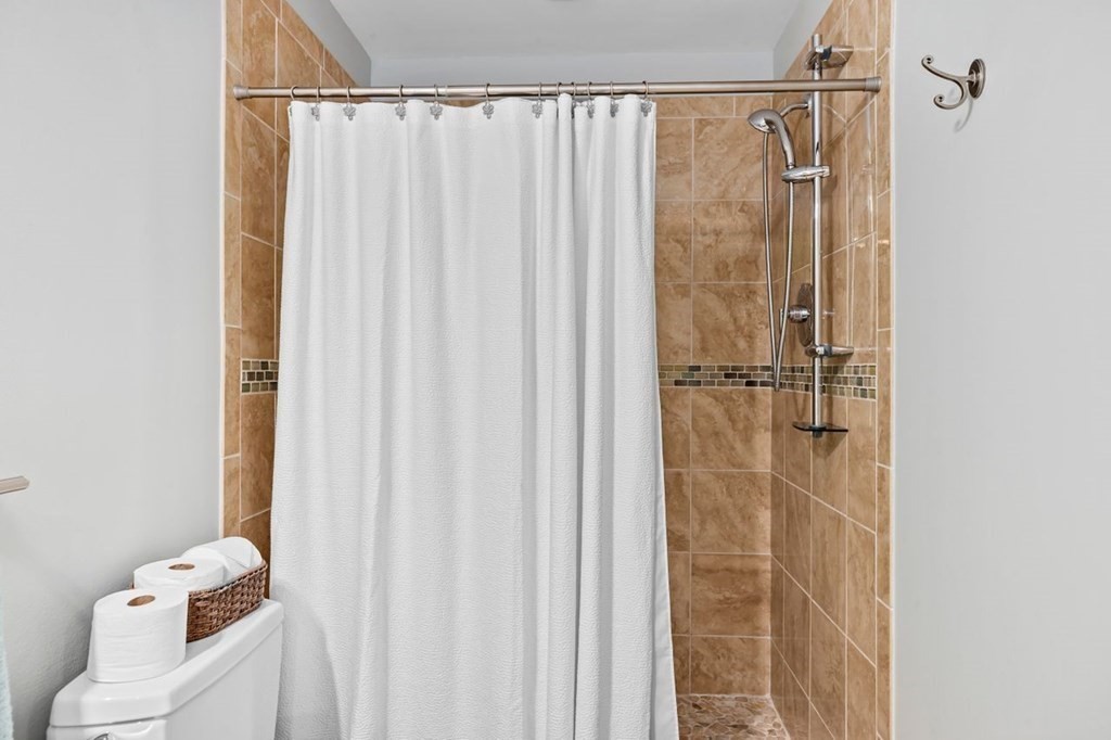 91 Front Street, Unit 104 Scituate, MA 02066 - Photo 20 of 26 a bathroom with a shower and a curtain