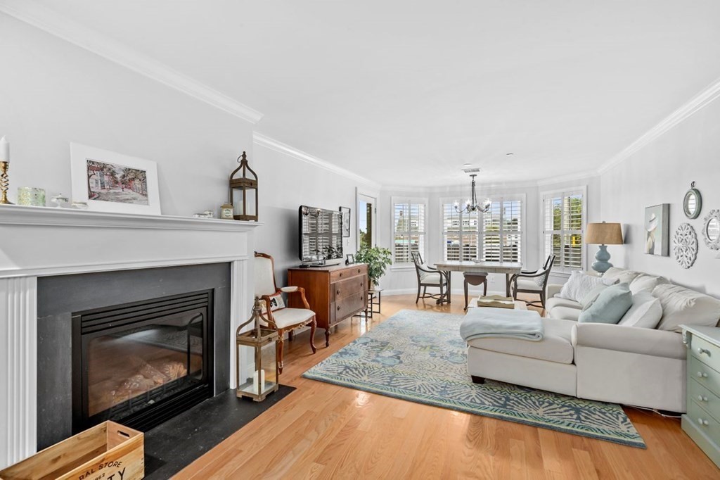 91 Front Street, Unit 104 Scituate, MA 02066 - Photo 2 of 26 a living room with furniture and a fireplace