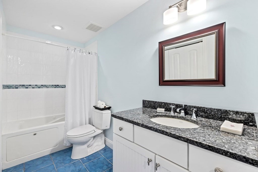 91 Front Street, Unit 104 Scituate, MA 02066 - Photo 22 of 26 a bathroom with a granite countertop sink toilet and shower