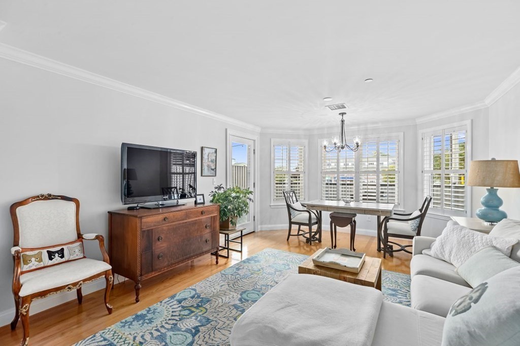 91 Front Street, Unit 104 Scituate, MA 02066 - Photo 3 of 26 a living room with furniture and a flat screen tv