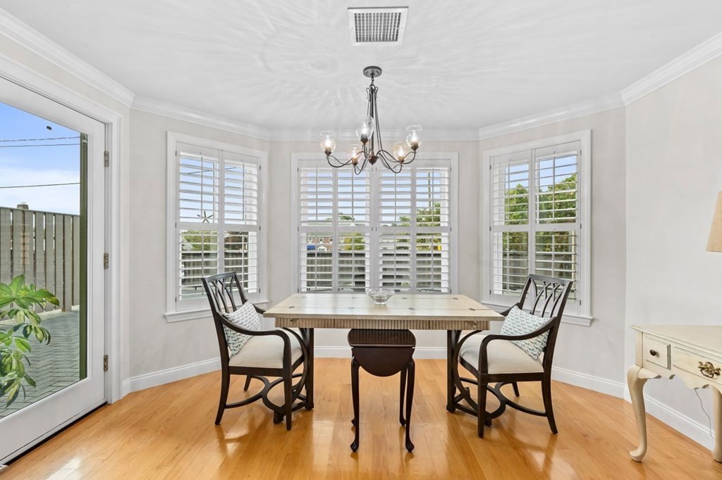 91 Front Street, Unit 104 Scituate, MA 02066 - Photo 4 of 26 a view of a dining room with furniture window and wooden floor