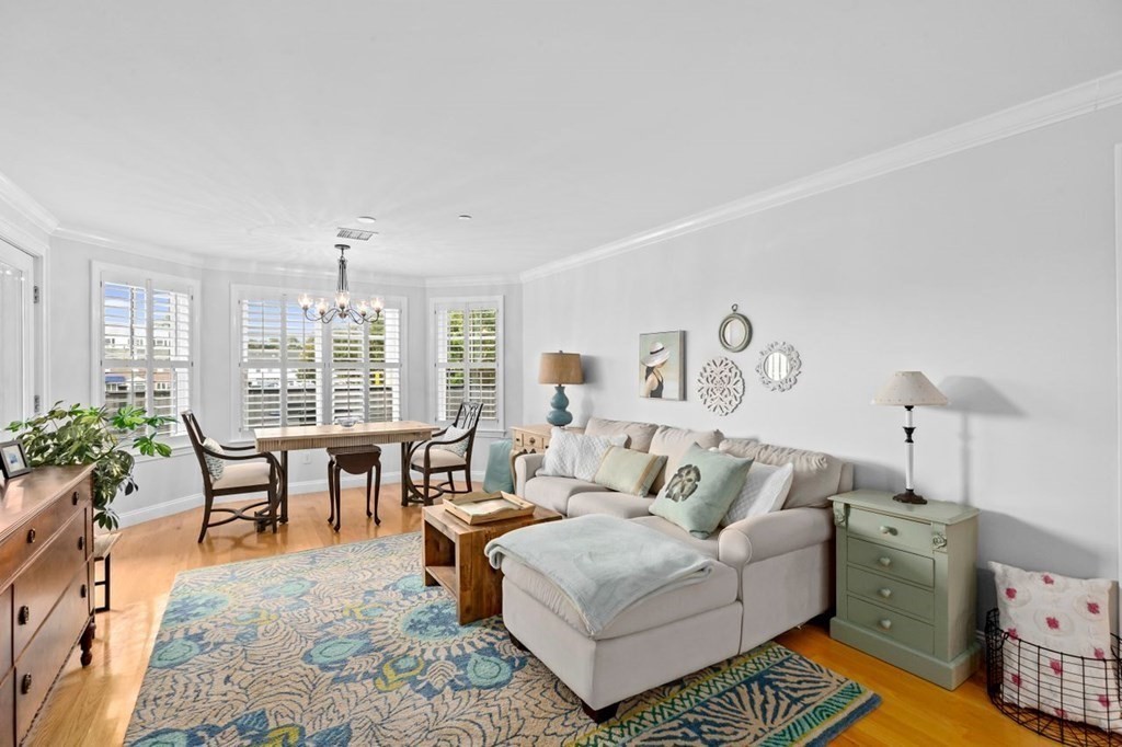 91 Front Street, Unit 104 Scituate, MA 02066 - Photo 8 of 26 a living room with furniture potted plant and a window