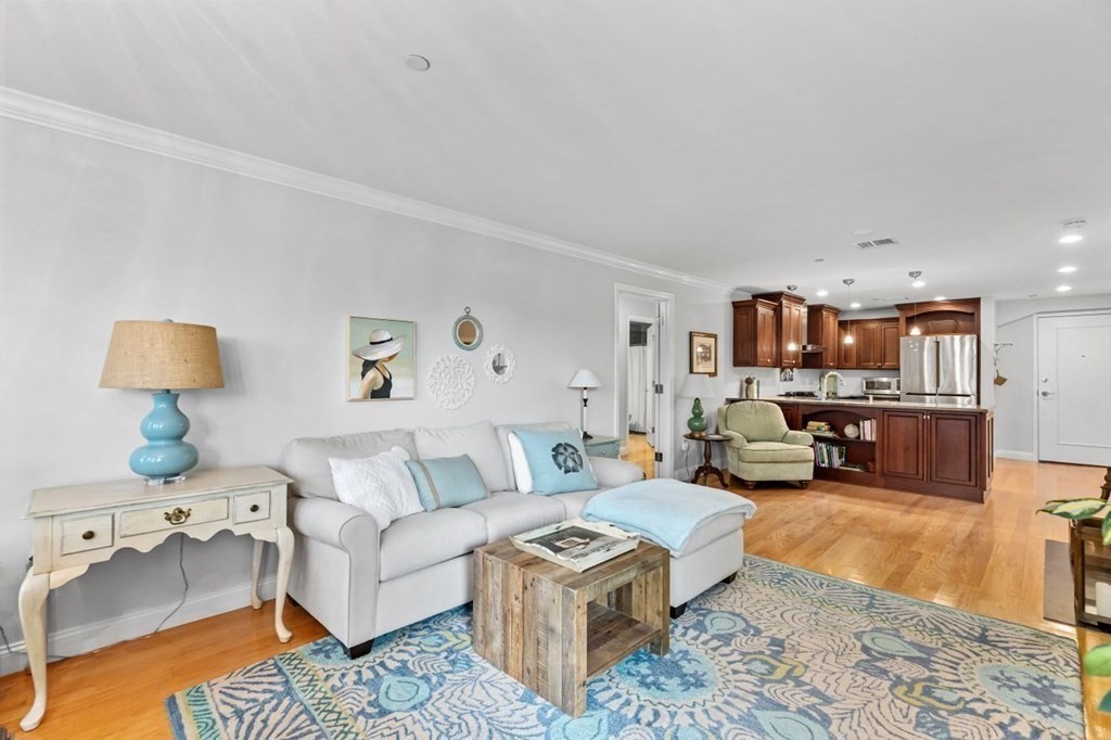 91 Front Street, Unit 104 Scituate, MA 02066 - Photo 9 of 26 a living room with furniture and a couch