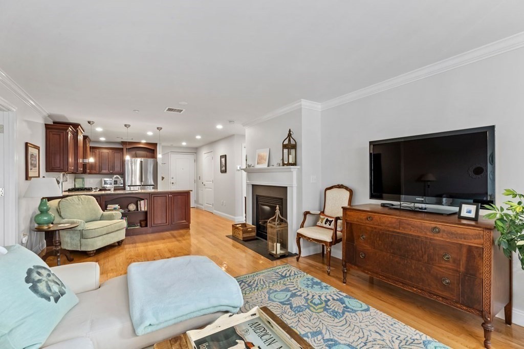 91 Front Street, Unit 104 Scituate, MA 02066 - Photo 10 of 26 a living room with furniture and a flat screen tv