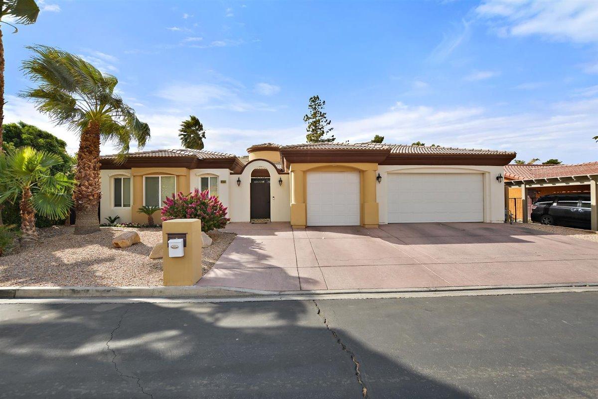 82553 Doolittle Drive Indio, CA 92201 - Photo 1 of 47 a front view of a house with a garden and yard