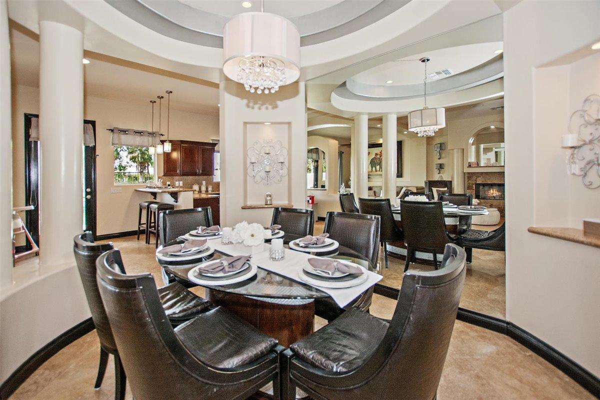 82553 Doolittle Drive Indio, CA 92201 - Photo 17 of 47 a dining room with wooden floor a chandelier a wooden table and chairs