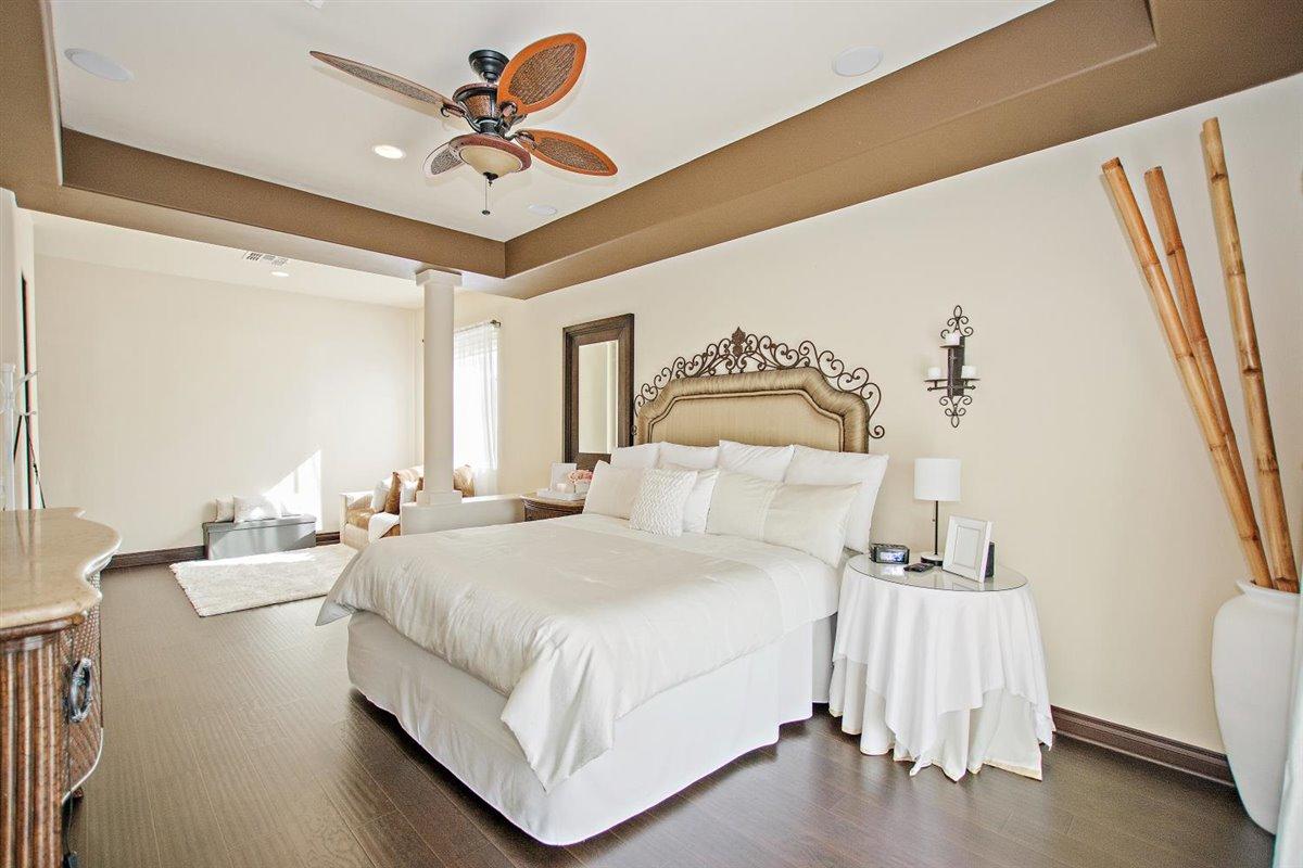 82553 Doolittle Drive Indio, CA 92201 - Photo 19 of 47 a bedroom with a bed and a chandelier