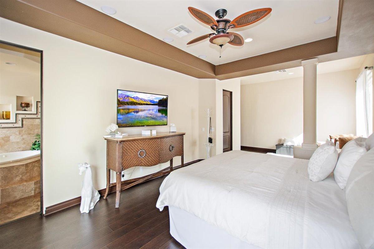 82553 Doolittle Drive Indio, CA 92201 - Photo 20 of 47 a bedroom with a bed and a flat screen tv