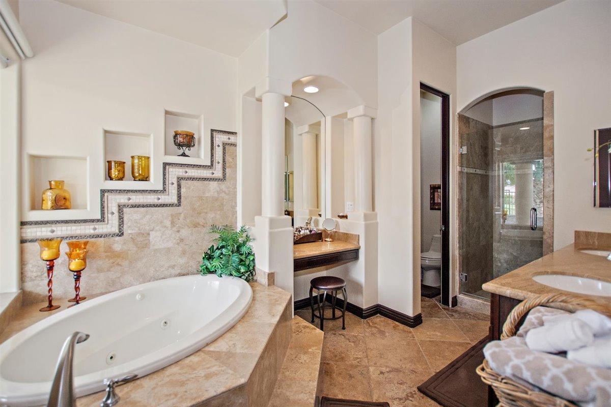 82553 Doolittle Drive Indio, CA 92201 - Photo 21 of 47 a bathroom with a tub double vanity sink and mirror