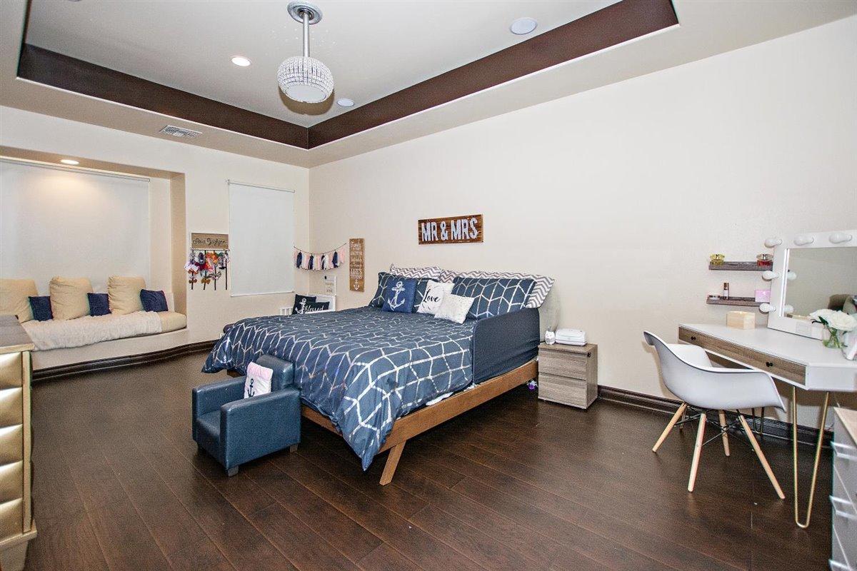 82553 Doolittle Drive Indio, CA 92201 - Photo 23 of 47 a bedroom with a bed and a table in it