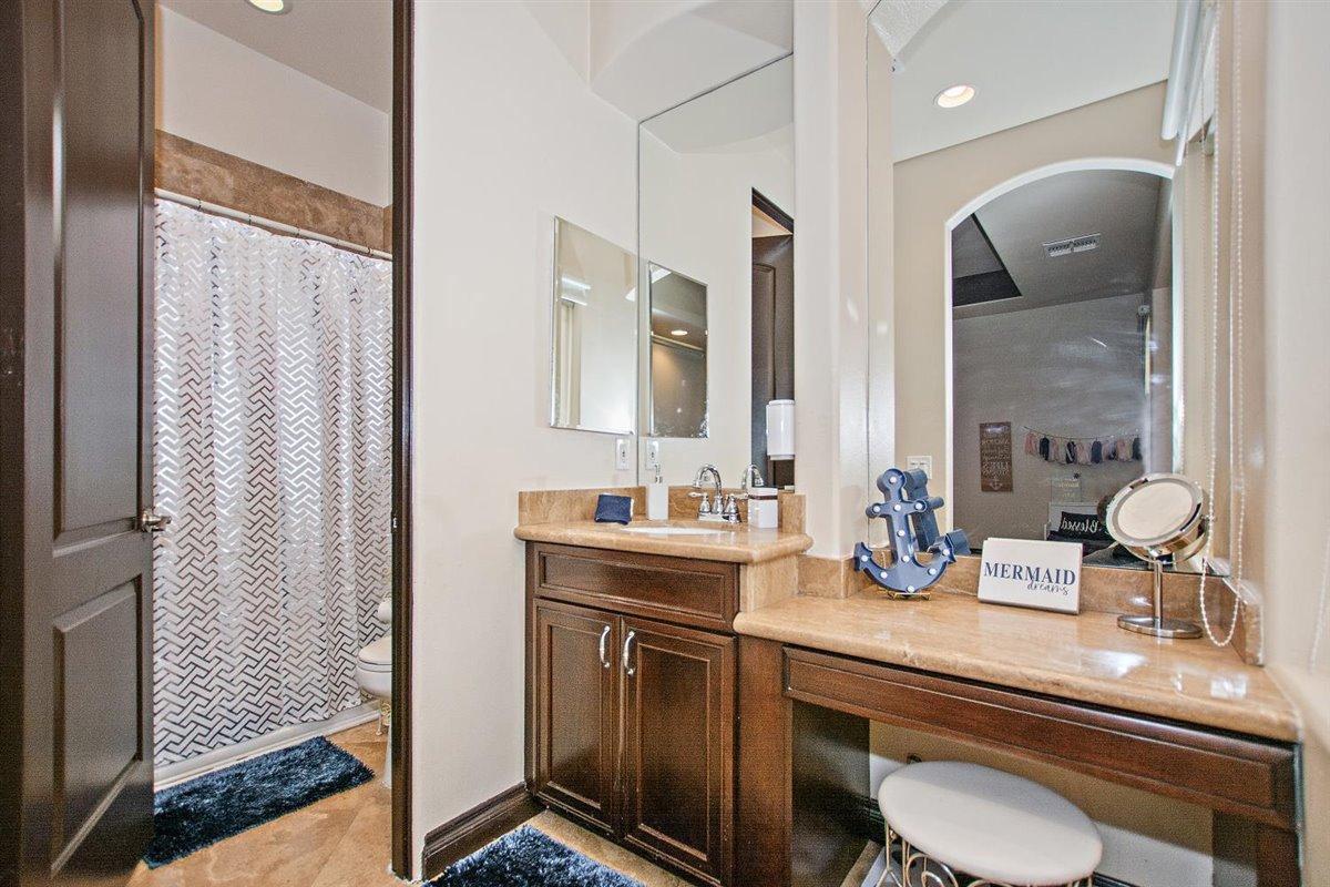 82553 Doolittle Drive Indio, CA 92201 - Photo 26 of 47 a bathroom with a double vanity sink and a mirror