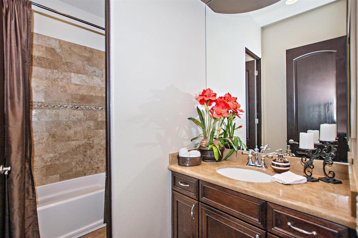 82553 Doolittle Drive Indio, CA 92201 - Photo 30 of 47 a bathroom with a granite countertop sink and a mirror