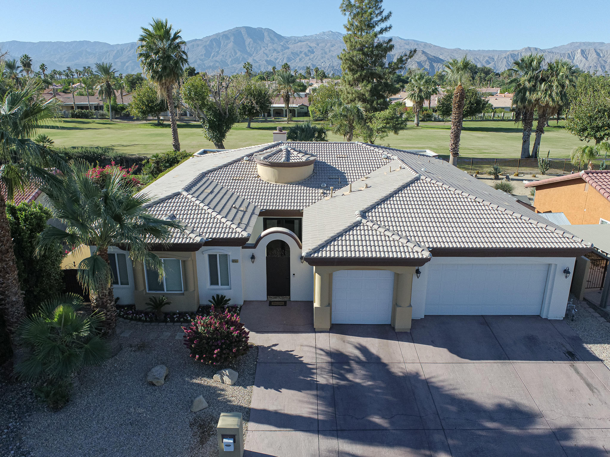 82553 Doolittle Drive Indio, CA 92201 - Photo 3 of 47 a front view of house with a garden and patio