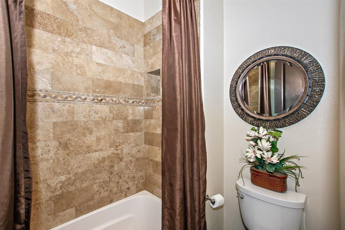 82553 Doolittle Drive Indio, CA 92201 - Photo 31 of 47 a bathroom with a toilet and a shower curtain