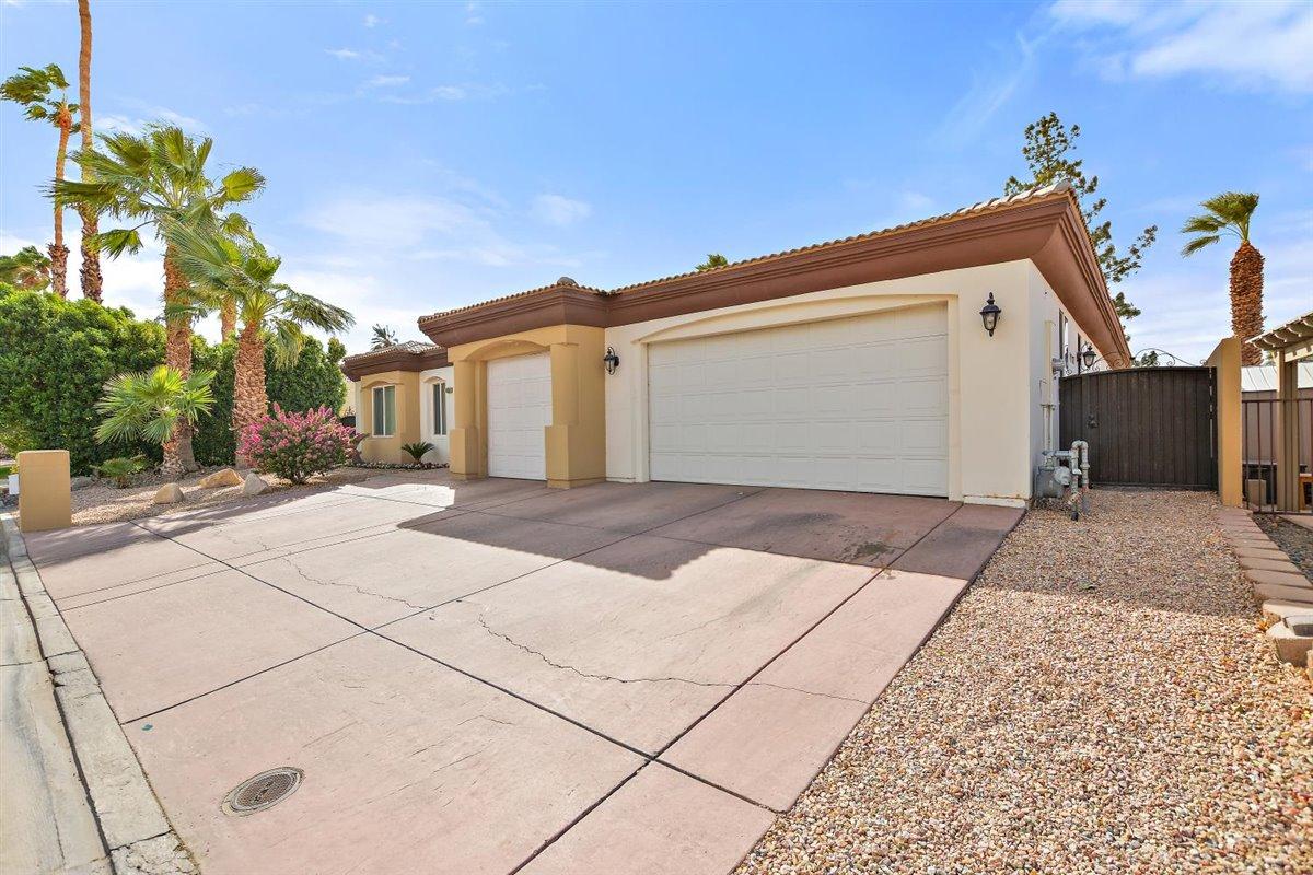 82553 Doolittle Drive Indio, CA 92201 - Photo 42 of 47 a view of a house with a yard and garage