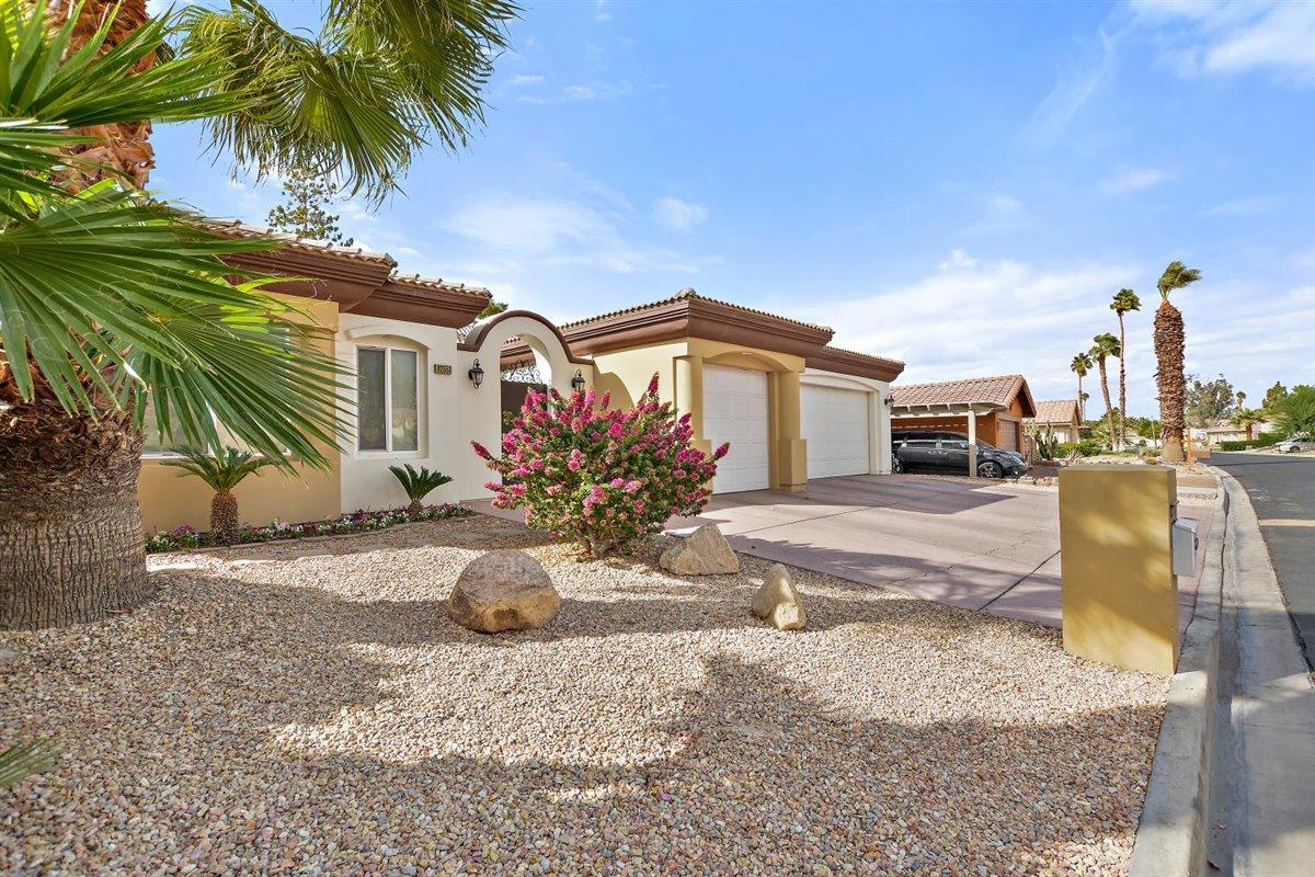 82553 Doolittle Drive Indio, CA 92201 - Photo 43 of 47 a front view of a house with a yard and garage