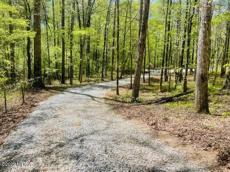 404 Old Scout Road Jackson, GA 30233 - Photo 3 of 13 a backyard of a house with a large trees