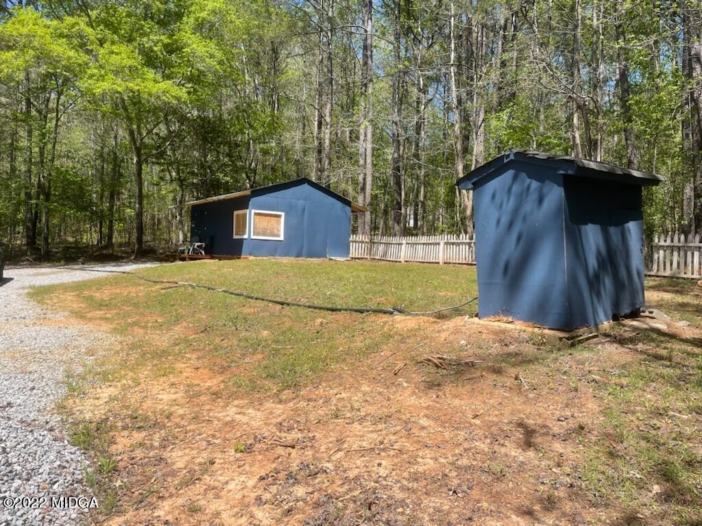 404 Old Scout Road Jackson, GA 30233 - Photo 8 of 13 a house with trees in the background