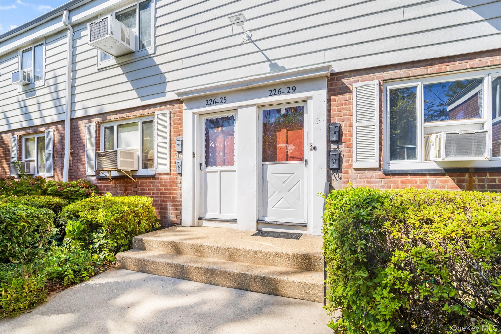 226-29 Manor Road, Unit UPPR Queens, NY 11427 - Photo 4 of 21 Doorway to property with brick siding