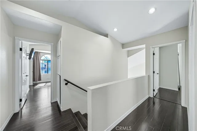 a view of hallway with wooden floor